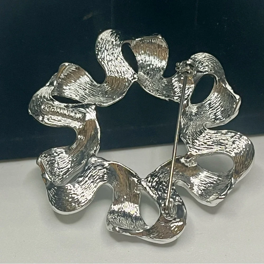 Two Elegant Silver tone Sarah Coventry brooches.
